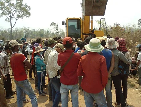 Smallholders working a field under threat of acquisition