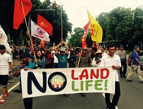 Farmers holding placards defending their land